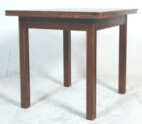 A vintage early 20th Century oak draw leaf dining table raised on straight leg supports having