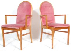 A matching pair of retro mid 20th Century teak framed dining carver chairs / armchairs having arched