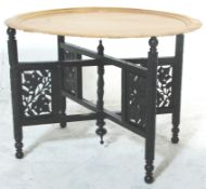 An early 20th Century asiatic - anglo colonial folding Binares brass opium table. The ebonised