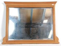 A Victorian 19th century mahogany overmantel mirror. The bevelled edge rectangular plate mirror