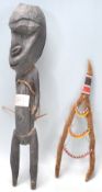 A carved tribal ebonised wooden figurine having an stylistically large head with short limbs