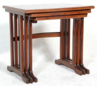 G Plan - A retro 20th Century mahogany nest of tables raised on shaped supports with each having a