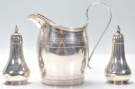 A Georgian silver hallmarked creamer jug having engraved banded decoration to the tapering body