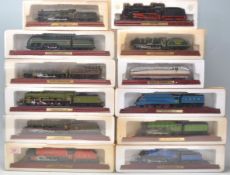 A group of twelve boxed 00 Gauge model trains on wooden plinth bases to include The Flying Scotsman,