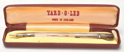 A mid 20th Century Yard O Led silver hallmarked propelling pencil having a faceted engine turned