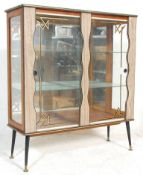 A retro mid 20th Century, circa 1950's formica china display cabinet vitrine. Raised on ebonised