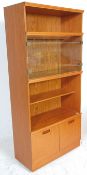 A retro mid 20th Century teak wood room unit having open shelves with a glazed door compartment