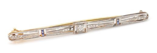 An 18ct gold, platinum and diamond Art Deco bar brooch. The pin having an open work design set