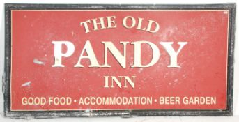 A large metal Welsh pub sign for 'The Old Pandy Inn, Good Food-Accommodation-Beer Garden'. The