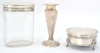 A group of three silver hallmarked wares to include a glass faceted pot having a silver cover