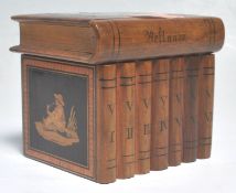 An early 20th Century antique Sorrento Ware puzzle box in the form of a stack of books, having
