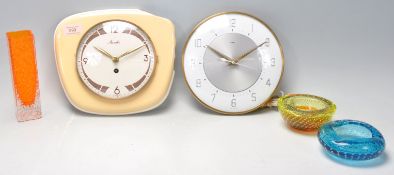 A retro mid 20th Century Mauthe made cream wall clock having Arabic and batten numeral markers.