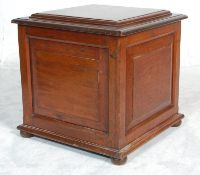 An early 19th Century mahogany cellarette / wine cooler with carved square panels set on bun feet.