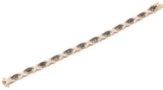 A sapphire and diamond bracelet with a 4 prong setting and a crossover decoration with a bayonet