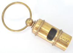 A brass replica whistle marked S Auld Maker Glasgow, RMS Glasgow White Line, with a large loop to