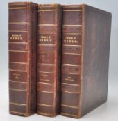 A good group of three leather bound Holy Bible books having gilt tooled spines with leather worked