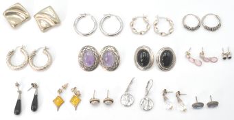 A large collection of silver earrings  and clips. To include creole hoop,  stone set with pierced