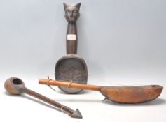 A group of three African tribal wooden objects to include a Dan tribe Liberian carved wooden