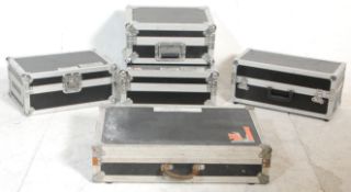 A group of five music equipment flight cases with some bearing makes plaques to include Total Impact