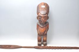 An African tribal fertility figurine having a large round stylised head dress, possibly Nigerian,