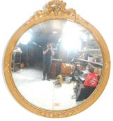 A 19th century gilt wood rococo convex wall mirror. The circular gilt frame with carved foliate top.