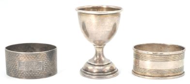 Two English silver hallmarked napkin rings with both having engine turned decoration with one