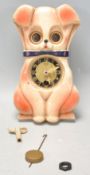 A vintage retro mid 20th Century Mi-Ken wall clock in the form of a dog having moving eyes. With