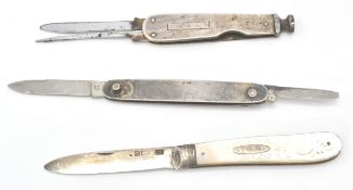 A group of three folding fruit knives to include a mother of pearl handle with a silver panel and