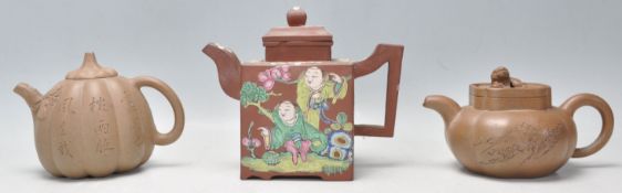 A collection of 3 Chinese terracotta yixing teapots. To include a hand painted red clay terracotta