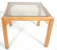 A vintage 20th Century 1970's teak wood and framed glass top coffee / occasional table of square