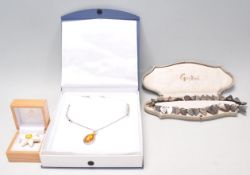 A collection of vintage jewellery to include a silver necklace having an amber cabochon pendant,