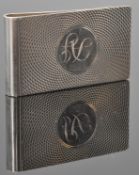 A silver hallmarked money clip having engine turned decoration around a central monogrammed