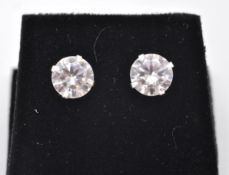 A pair of stamped sterling silver and a round brilliant cut CZ earrings with a 4 prong setting