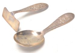 An early 20th Century 1930's silver hallmarked baby / child's spoon with pusher each having raised '