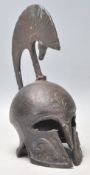 A vintage 20th Century heavy bronze Trojan Helmet having moulded rams head decoration. Measures 21cm