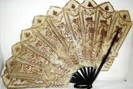 An antique 19th century Indian / Asiatic style hide / skin ladies fan. Usual form, with painted hide