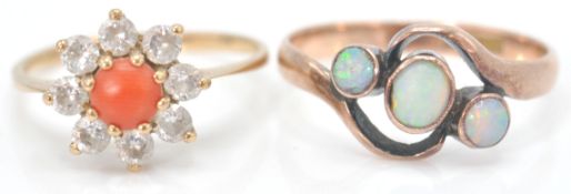 A 9ct gold hallmarked coral and white stone cluster ring. The central cabochon coral with halo of