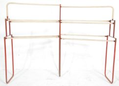 A vintage retro industrial 20th Century metal framed towel / shoe rack having a red painted frame