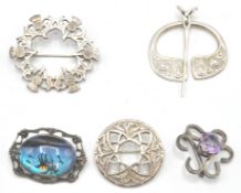 A collection of 4 silver hallmarked / 925 Scottish brooches to include a celtic knot, roundel