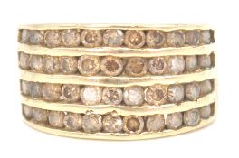 An early 20th century 18ct gold and champagne diamond channel set ring. The ring with 11 mixed cut