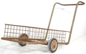 A vintage mid 20th Century industrial / factory trolley of metal tubular construction raised in