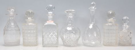 A group of seven vintage and antique cut glass decanters to include a pair of whiskey decanters with