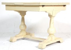 A vintage early 20th Century oak drawer leaf table having paneled leafs with bulbous supports raised