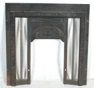 An antique Edwardian Art Nouveau Cast Iron Fireplace surround finely decorated with foliate swirls
