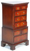 A Georgian revival small mahogany tallboy chest of drawers raised on bracket feet with a series of