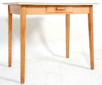 A vintage retro mid 20th Century formica topped dining table having a red patterned finish raised on