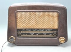 A 1930's Art Deco bakelite valve radio by Cossor. The domed bakelite case with decorative black dial