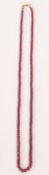 A beaded necklace of graduating faceted rubies hav