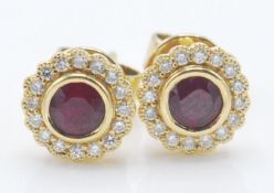 A pair of 18ct gold stud earrings being set with r
