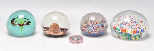 A group of five glass paperweights to include mill